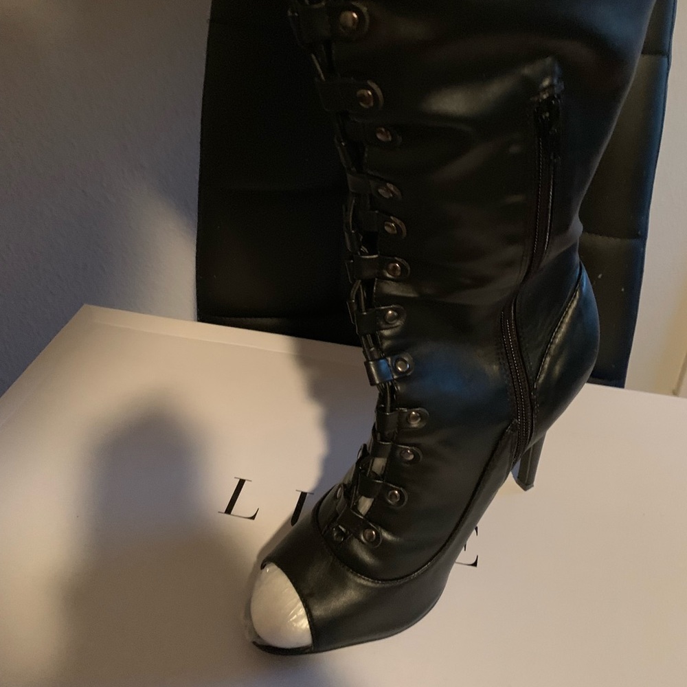 Peep Toe, over the knee Lace up boots.
